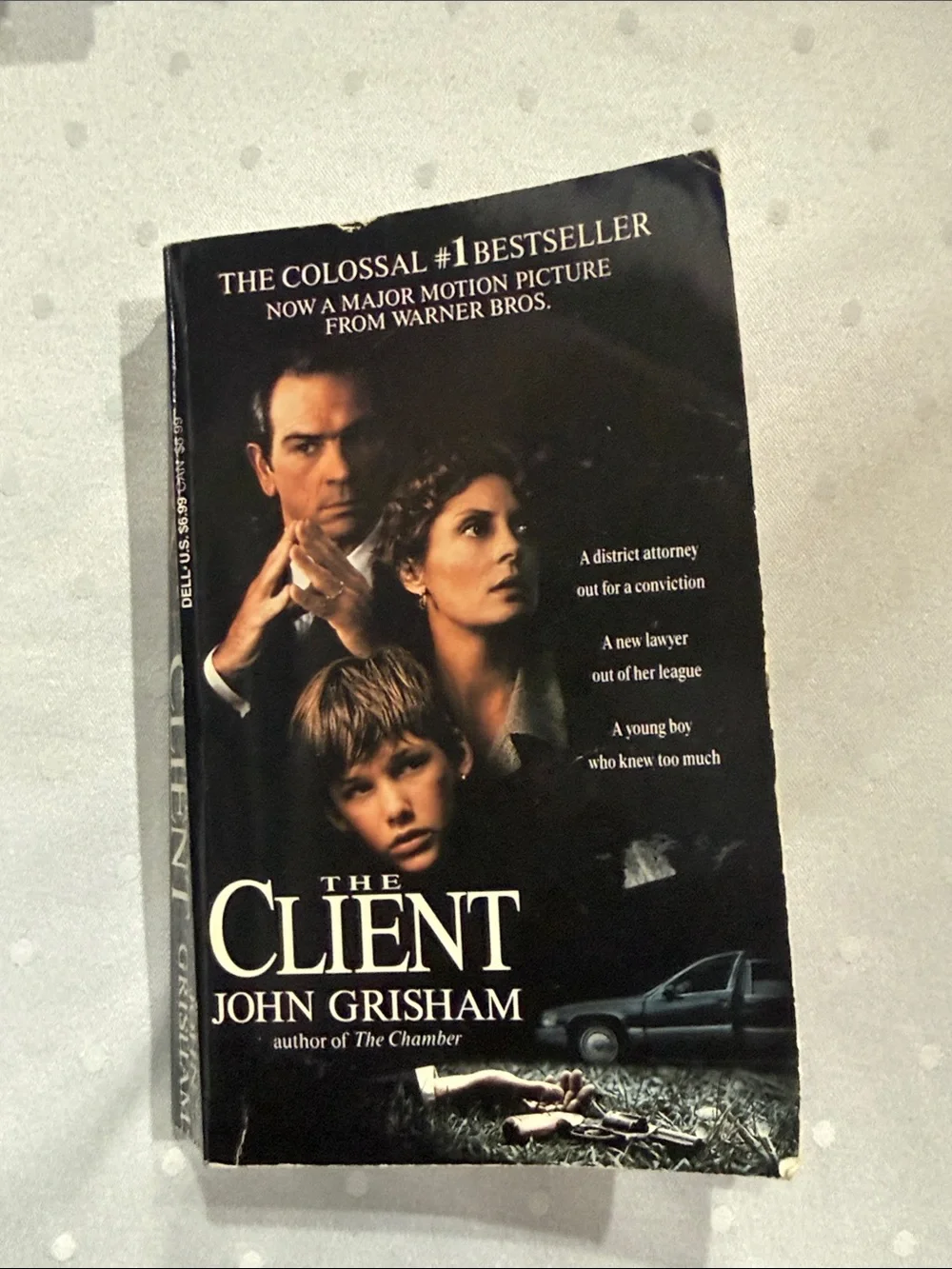 “The Client” a paperback novel by John Grisham
